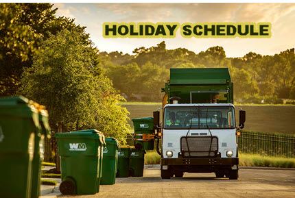 Garbage truck with carts on the side of the street including words Holiday Schedule