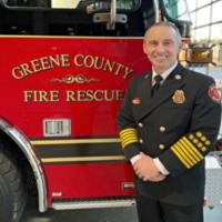 Chief Wiggins standing in front of a fire truck