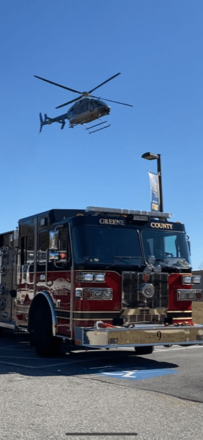 Helicopter hovering over a fire truck.