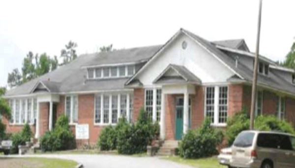 Brick Building with cars parked in front
